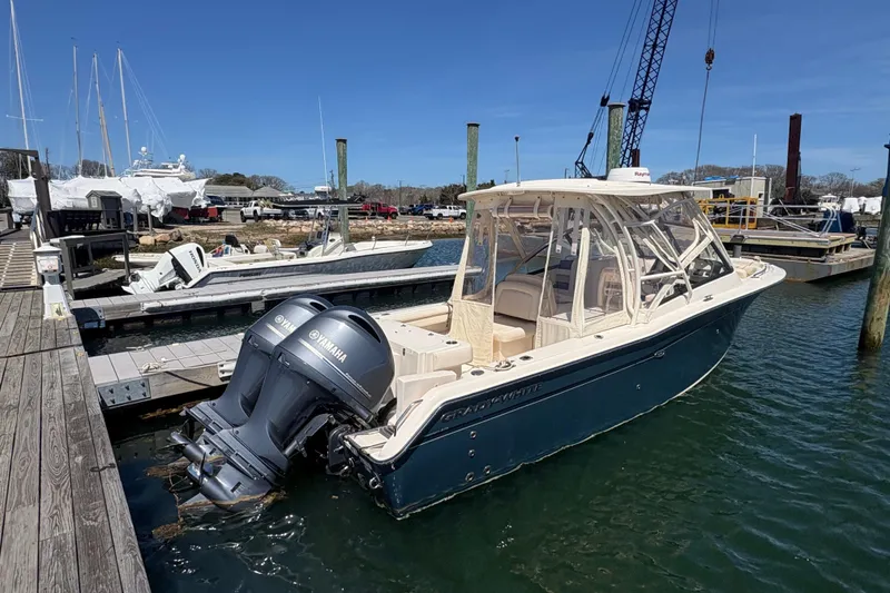 Slide: The Image of 2016 Grady-White Freedom 275 boat docked with twin Yamaha engines. - 2
