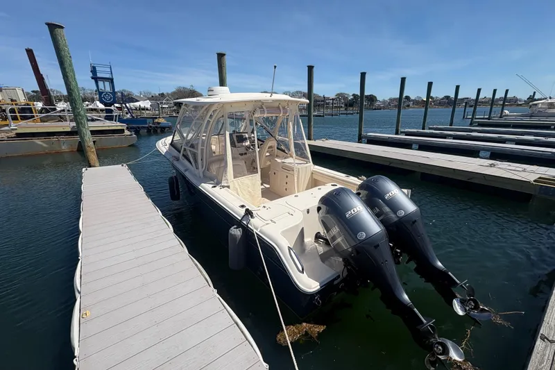 Slide: The Image of 2016 Grady-White Freedom 275 boat docked with twin Yamaha outboard engines. - 3