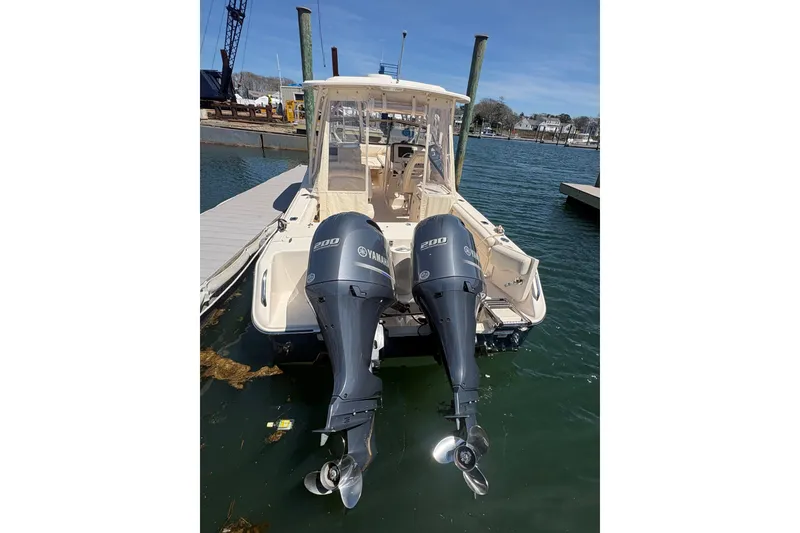 Slide: The Image of 2016 Grady-White Freedom 275 boat with twin Yamaha 200 engines docked at marina. - 4