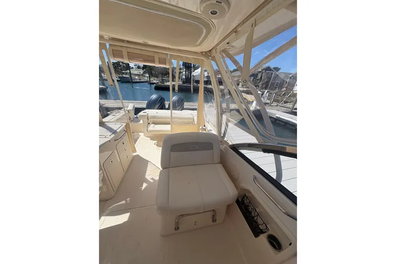 Slide: The Image of 2016 Grady-White Freedom 275 boat interior with seating and waterfront view. - 9