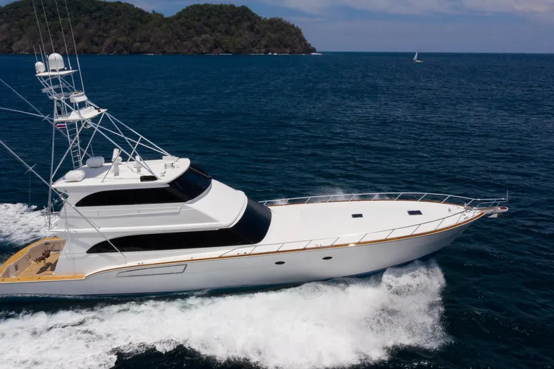 Slide: The Image of 2001 Donzi yacht cruising on the ocean with lush green islands in the background. - 11