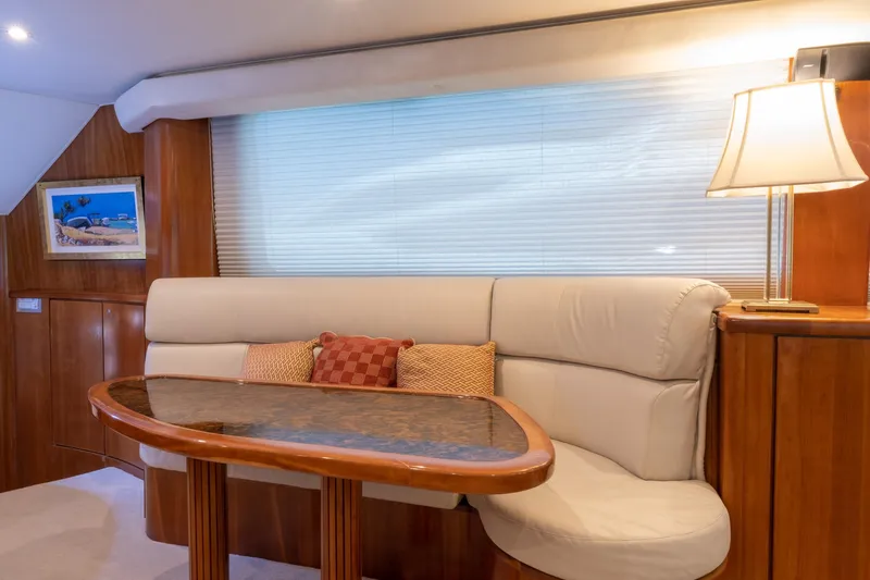 Slide: The Image of Luxurious 2001 Donzi yacht interior with elegant seating, wooden table, and ambient lighting. - 25