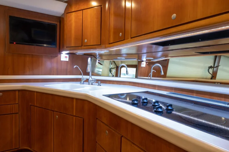 Slide: The Image of Luxurious 2001 Donzi yacht kitchen with wooden cabinets, modern appliances, and sleek countertops. - 27