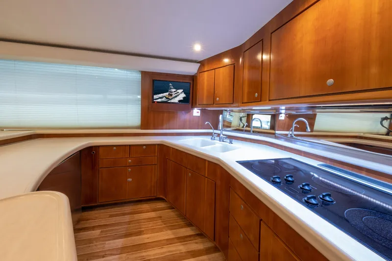 Slide: The Image of Luxurious 2001 Donzi yacht kitchen with wooden cabinetry and modern appliances. - 28