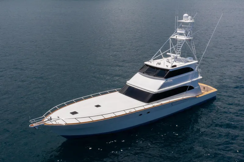 Slide: The Image of 2001 Donzi yacht on calm blue water, featuring sleek design and spacious deck. - 3