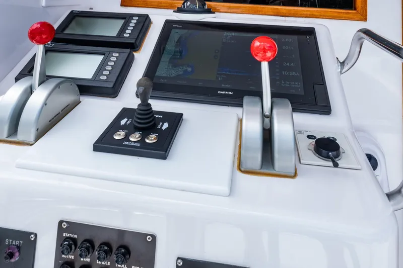 Slide: The Image of Control panel of a 2001 Donzi boat with navigation screens and throttle levers. - 34