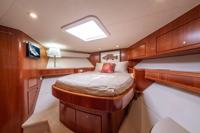 Slide: The Image of Luxurious 2001 Donzi yacht cabin with wood paneling and cozy bed. - 36
