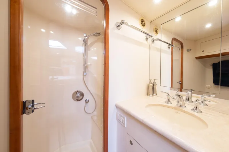 Slide: The Image of Luxurious 2001 Donzi yacht bathroom with shower, elegant fixtures, and large mirror. - 38