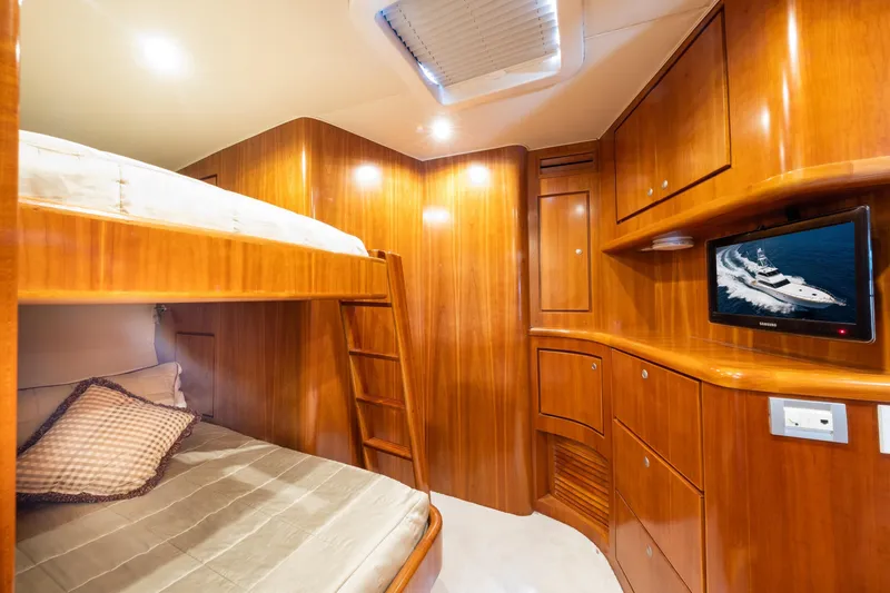 Slide: The Image of Luxurious 2001 Donzi yacht cabin with wooden interior, bunk beds, and wall-mounted TV. - 40