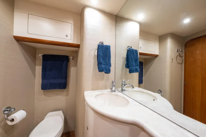 Slide: The Image of Luxurious 2001 Donzi yacht bathroom with dual sinks, blue towels, and elegant fixtures. - 41