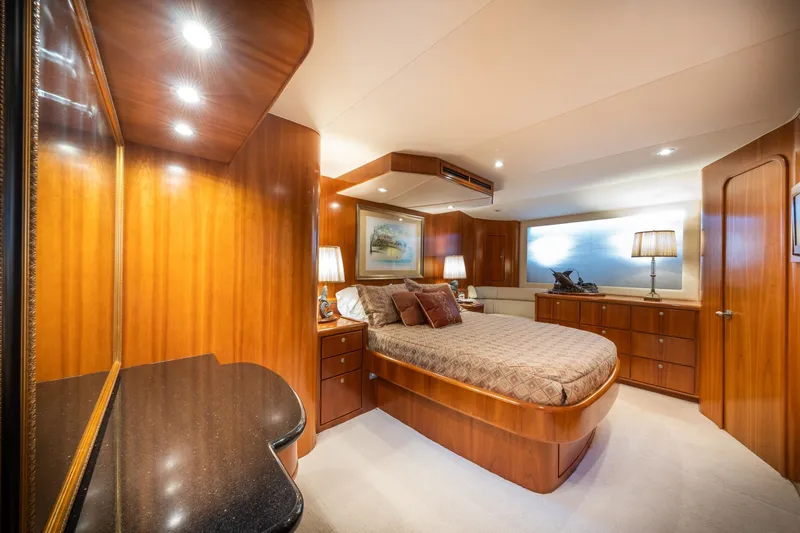 Slide: The Image of Luxurious 2001 Donzi yacht bedroom with elegant wood paneling and ambient lighting. - 45