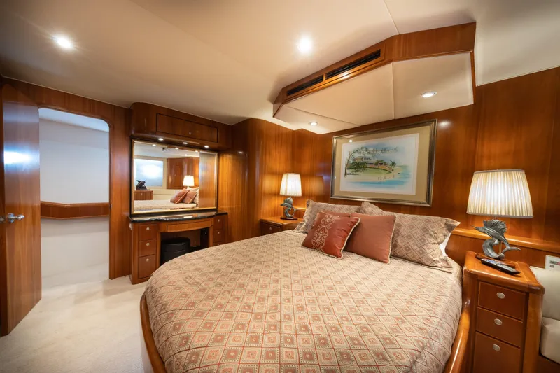 Slide: The Image of Luxurious 2001 Donzi yacht bedroom with elegant wood paneling and cozy bedding. - 47