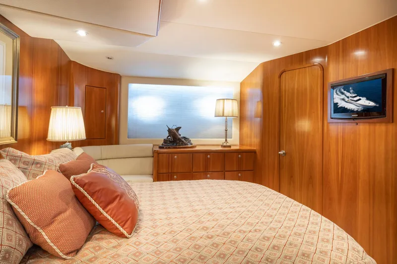 Slide: The Image of Luxurious 2001 Donzi yacht bedroom with elegant wood paneling and cozy bedding. - 48