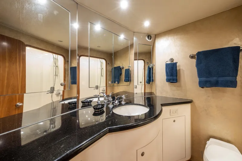 Slide: The Image of Luxurious 2001 Donzi yacht bathroom with sleek black countertop and elegant fixtures. - 49