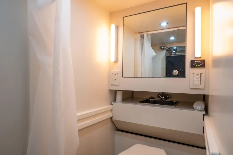 Slide: The Image of Compact 2001 Donzi boat bathroom with mirror, sink, and modern lighting. - 51