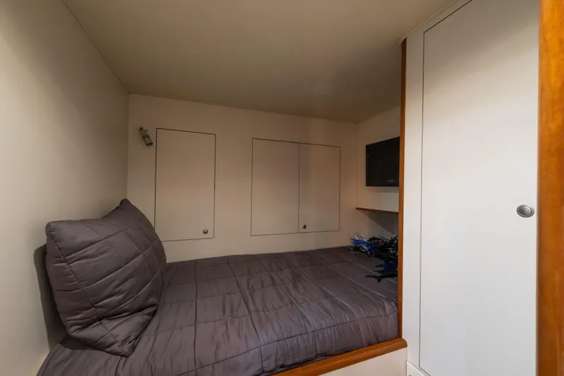 Slide: The Image of Compact cabin interior of a 2001 Donzi boat with a cozy bed and storage. - 52