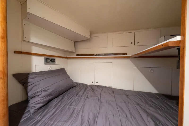 Slide: The Image of Cozy cabin interior of a 2001 Donzi boat with a neatly made bed. - 54