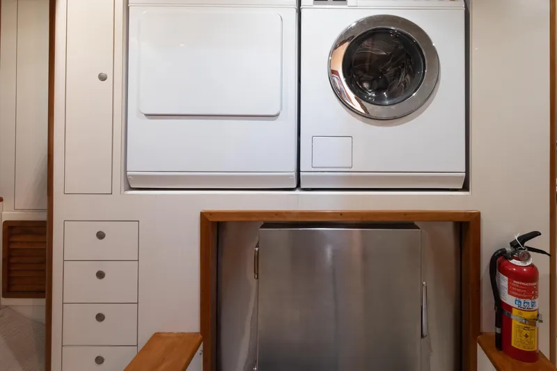 Slide: The Image of Laundry area on a 2001 Donzi boat with washer, dryer, and fire extinguisher. - 55