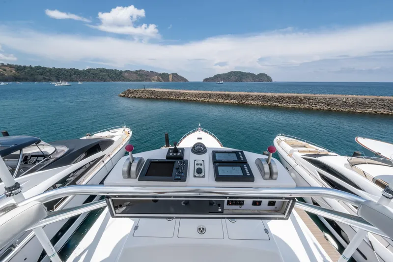 Slide: The Image of Cockpit view of a 2001 Donzi boat overlooking a serene marina and ocean. - 56