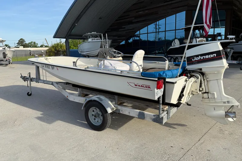 Slide: The Image of 1983 Boston Whaler Sport 15 boat on trailer with Johnson outboard motor. - 3
