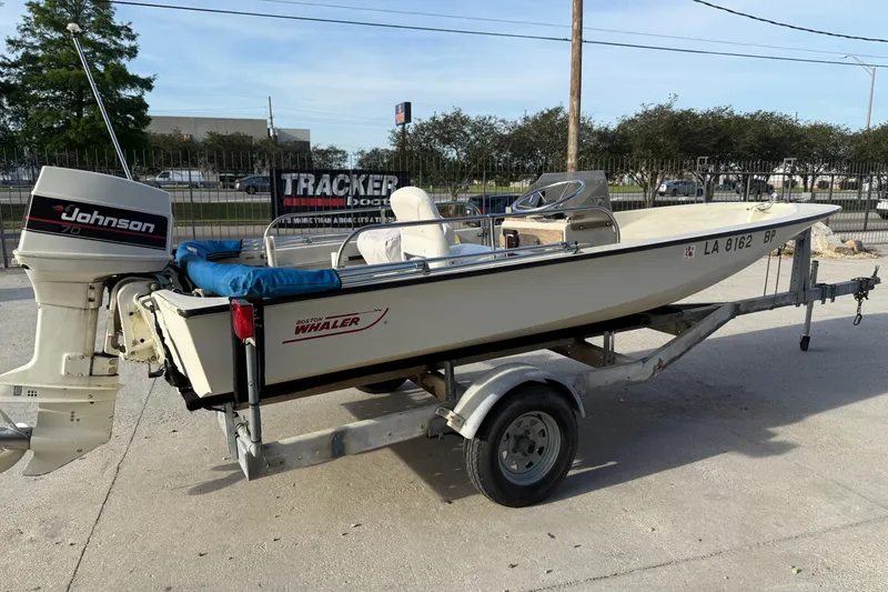 Slide: The Image of 1983 Boston Whaler Sport 15 boat on trailer with Johnson outboard motor. - 7