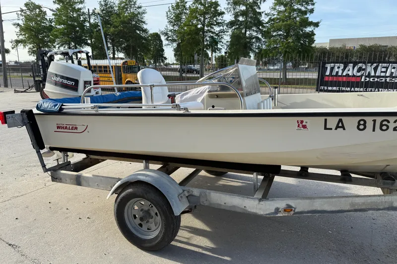 Slide: The Image of 1983 Boston Whaler Sport 15 boat on trailer with Johnson outboard motor. - 8