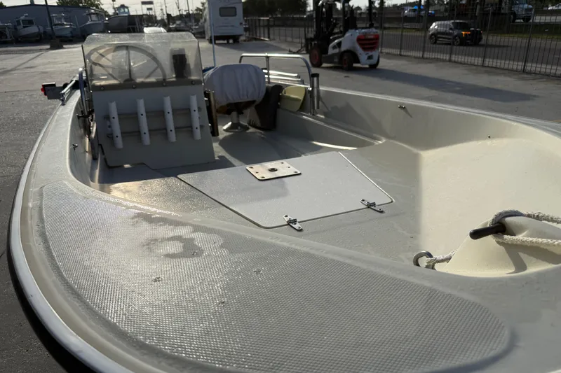 Slide: The Image of 1983 Boston Whaler Sport 15 boat with open deck and fishing rod holders. - 9