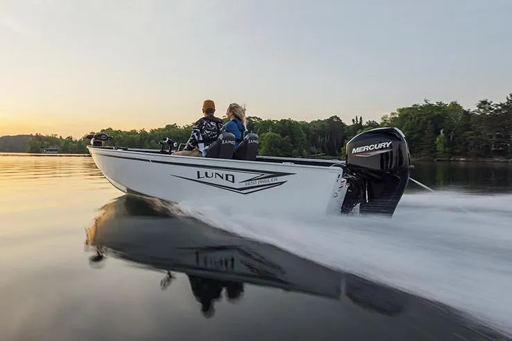 The Image of Manufacturer Provided Image: 2025 Lund 1650 Angler SS boat cruising on a serene lake at sunset. - 0