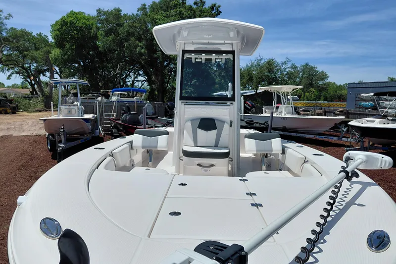 Slide: The Image of 2023 Robalo 246 Cayman boat with center console, docked outdoors under clear skies. - 10