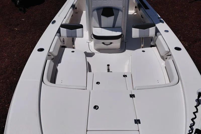 Slide: The Image of 2023 Robalo 246 Cayman boat interior with seating and storage compartments. - 13