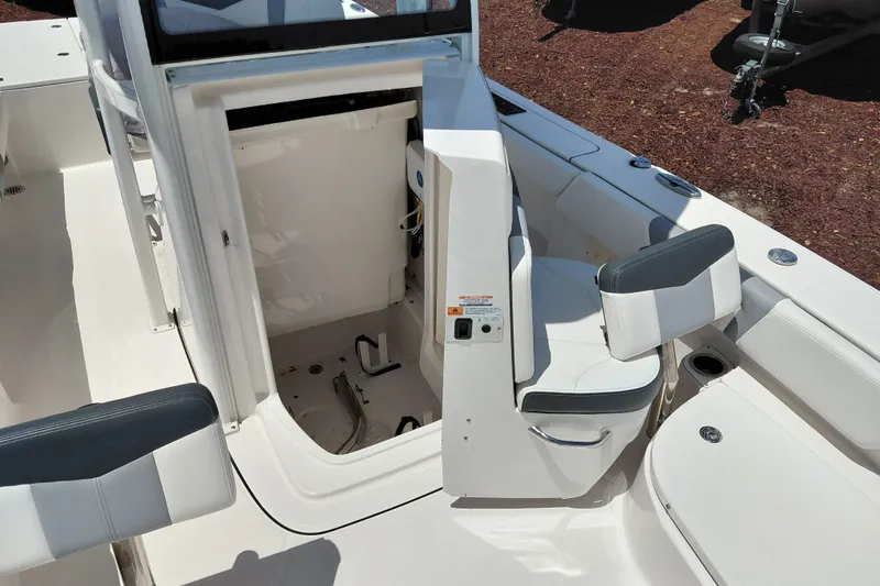 Slide: The Image of 2023 Robalo 246 Cayman boat interior with open storage compartment and seating. - 21