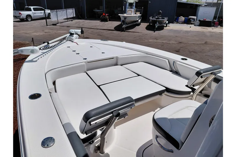 Slide: The Image of 2023 Robalo 246 Cayman boat interior with cushioned seating and sleek design. - 25