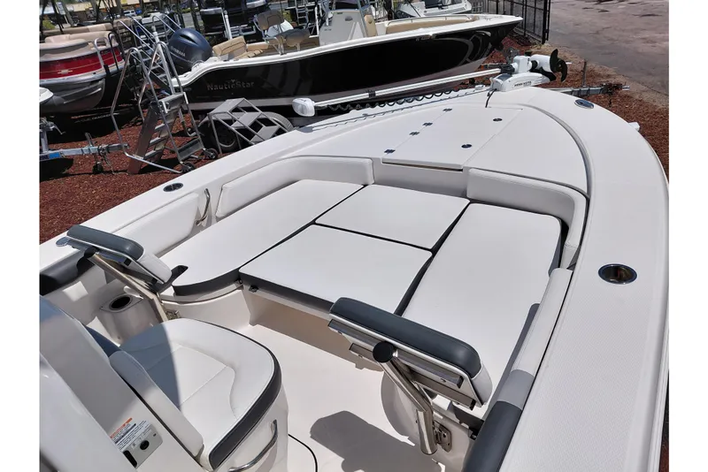 Slide: The Image of 2023 Robalo 246 Cayman boat interior with cushioned seating and storage compartments. - 26