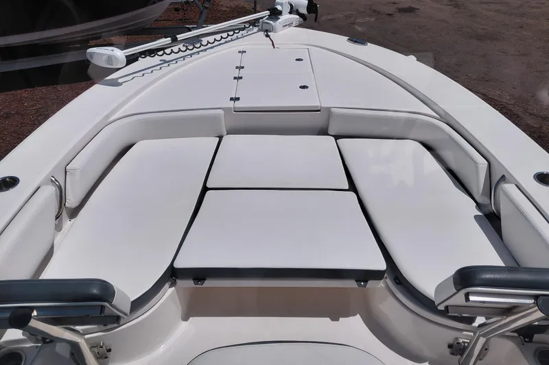 Slide: The Image of 2023 Robalo 246 Cayman boat interior with cushioned seating and storage compartments. - 27