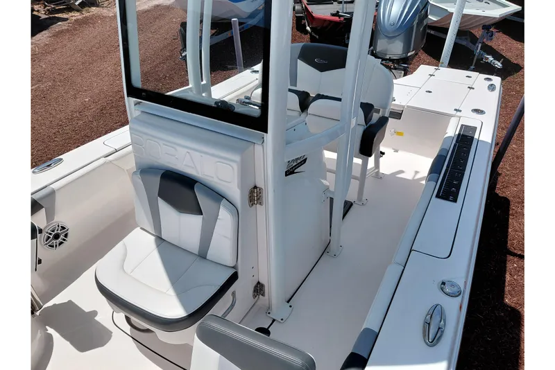 Slide: The Image of 2023 Robalo 246 Cayman boat interior with seating and console, showcasing modern design. - 28