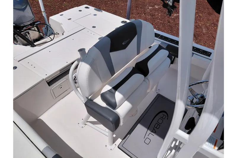 Slide: The Image of 2023 Robalo 246 Cayman boat interior with dual seating and steering wheel. - 31