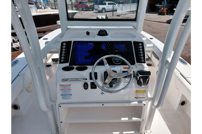 Slide: The Image of 2023 Robalo 246 Cayman boat console with steering wheel and navigation display. - 33