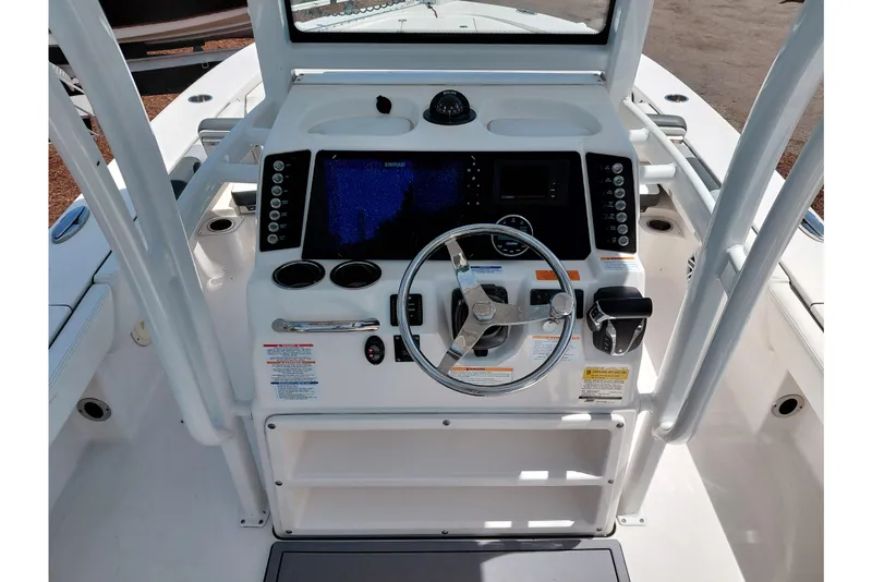 Slide: The Image of 2023 Robalo 246 Cayman boat console with steering wheel and navigation controls. - 37