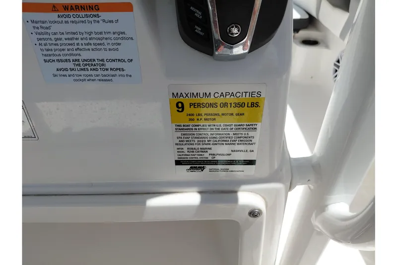 Slide: The Image of 2023 Robalo 246 Cayman capacity label, maximum 9 persons or 1350 lbs, safety warnings. - 39