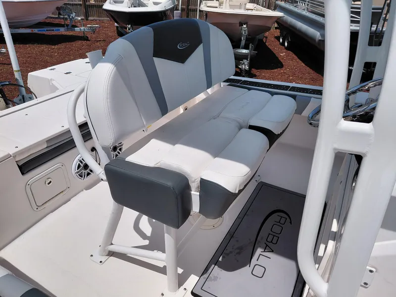 Slide: The Image of 2023 Robalo 246 Cayman boat interior with cushioned seating and branded floor mat. - 40