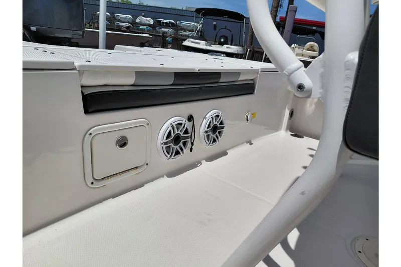 Slide: The Image of 2023 Robalo 246 Cayman boat interior with speakers and storage compartment. - 41