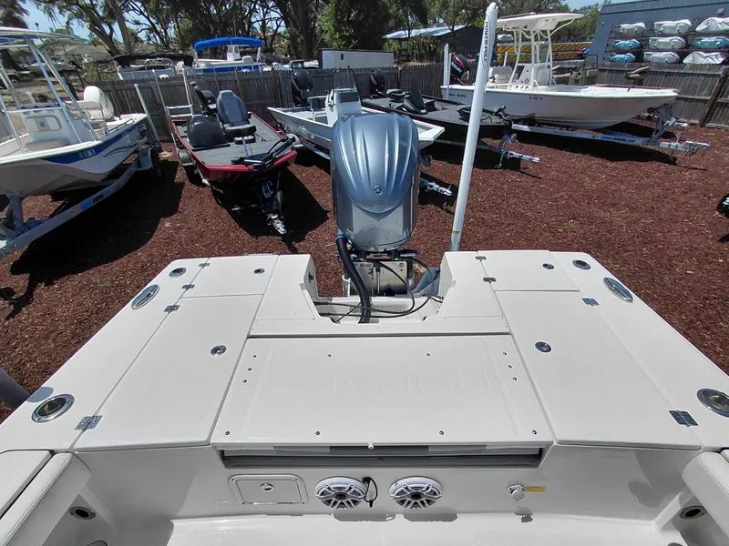 Slide: The Image of 2023 Robalo 246 Cayman boat with outboard motor, displayed in a boatyard setting. - 42