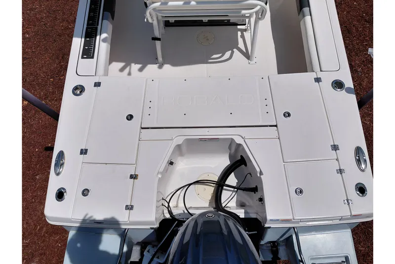 Slide: The Image of 2023 Robalo 246 Cayman boat deck with storage compartments and seating area. - 55