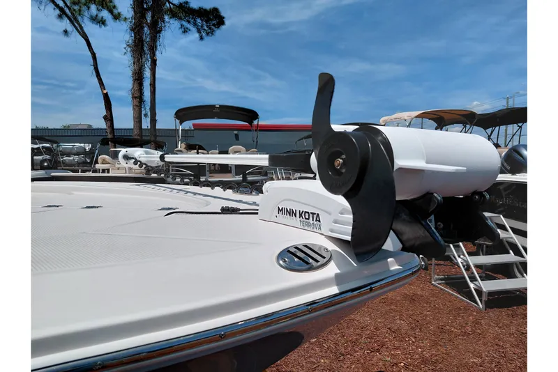 Slide: The Image of 2023 Robalo 246 Cayman boat with Minn Kota Terrova trolling motor, displayed outdoors. - 57