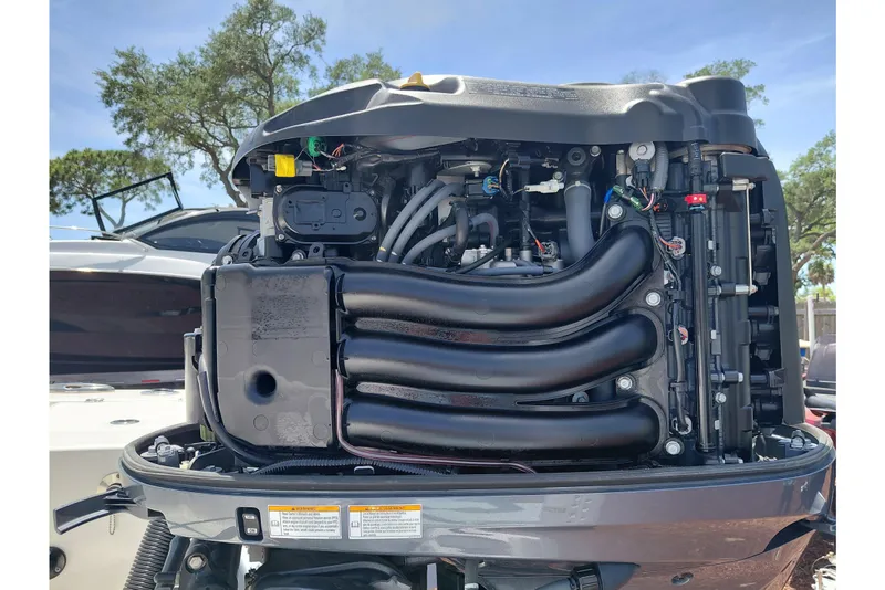 Slide: The Image of 2023 Robalo 246 Cayman boat engine, detailed view under sunny sky. - 60
