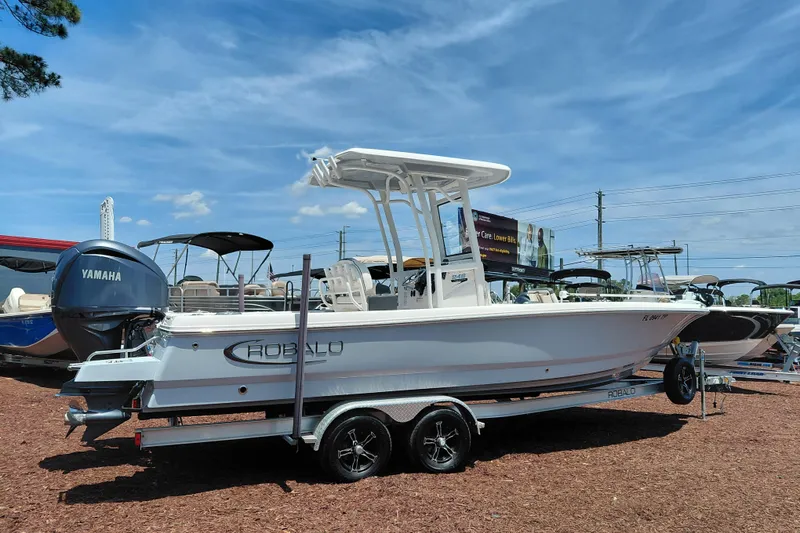 Slide: The Image of 2023 Robalo 246 Cayman boat with Yamaha engine on trailer, displayed outdoors. - 8