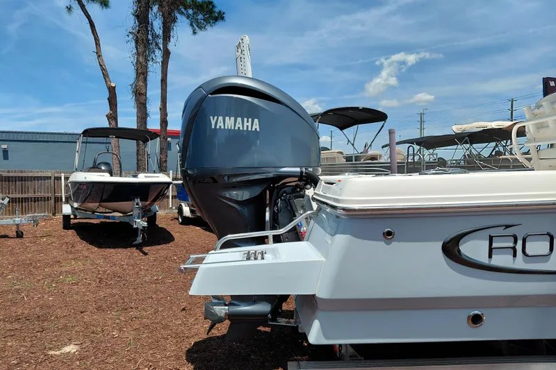 Slide: The Image of 2023 Robalo 246 Cayman boat with Yamaha engine displayed outdoors. - 9