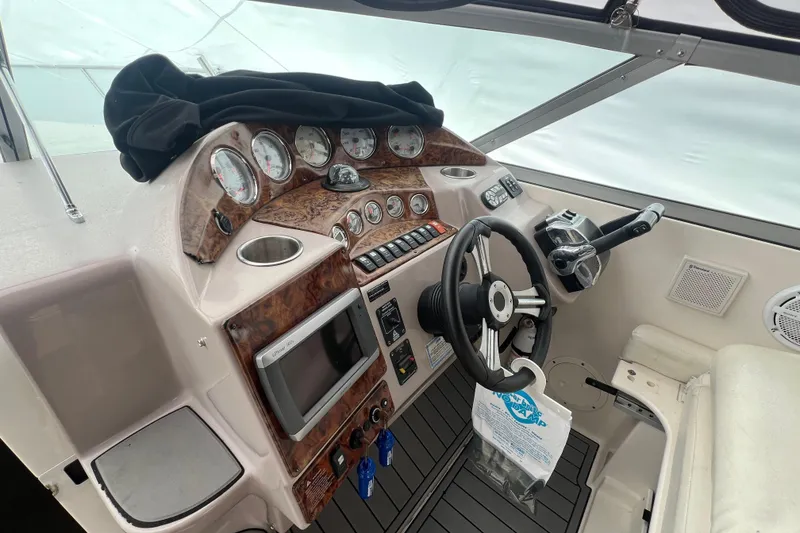 Slide: The Image of Cockpit of 2005 Rinker Fiesta Vee 320 boat with steering wheel and control panel. - 4