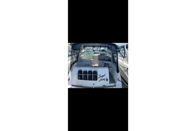Slide: The Image of 2005 Rinker Fiesta Vee 320 boat docked, featuring spacious seating and sleek design. - 9