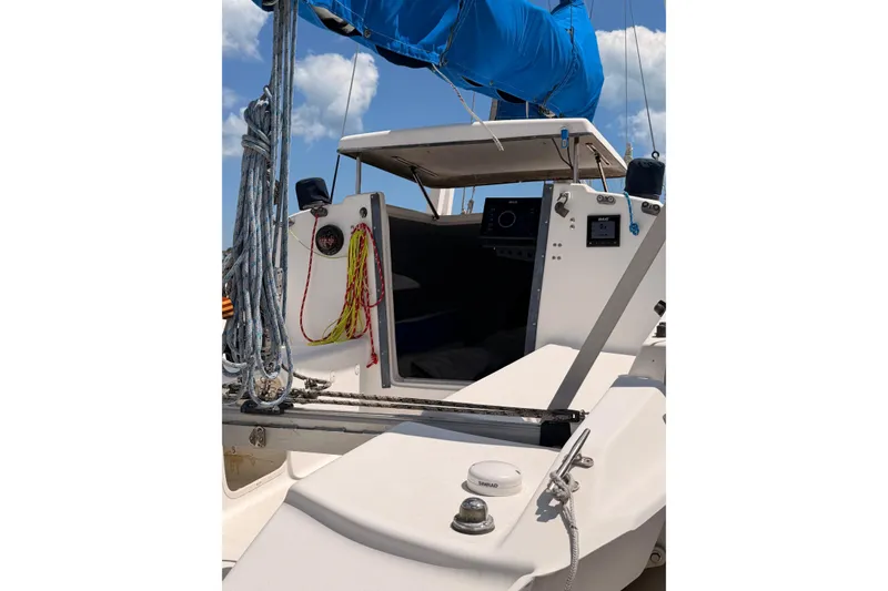 Slide: The Image of 2000 Corsair F-24 MkII sailboat cockpit with ropes and navigation equipment under blue sky. - 13